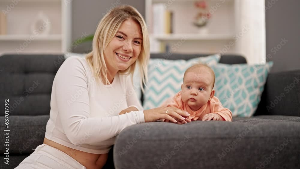 Mother and daughter sitting together smiling at home Mother and daughter sitting together smiling at home