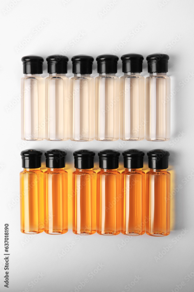 Bottles of cosmetic products on white background, flat lay Bottles of cosmetic products on white background, flat lay