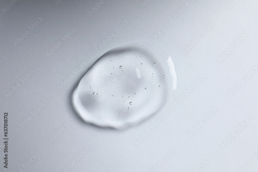 Drop of cosmetic oil on white background, top view Drop of cosmetic oil on white background, top view