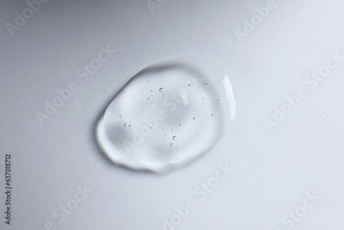 Drop of cosmetic oil on white background, top view © New Africa