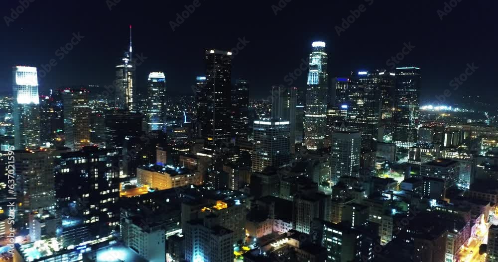 Aerial Backward Shot Of Illuminated Towers In City At Night, Drone Flying Over Cityscape - Los Angeles, California