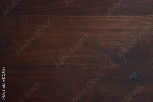 Closeup dark texture of black walnut wood surface toned with organic oil