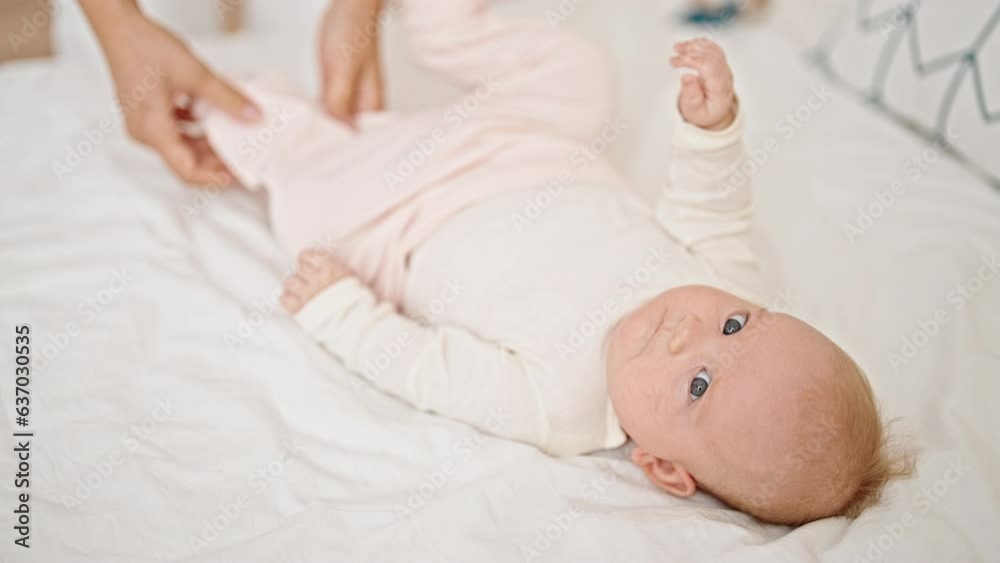 Mother and daughter wearing pyjama lying on bed at bedroom Mother and daughter wearing pyjama lying on bed at bedroom