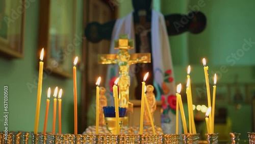 Burning candles in the temple. Orthodox cross, crucifixion. Religion. Christian faith in God. photo