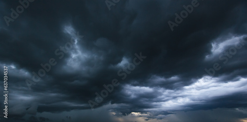 The dark sky with heavy clouds converging and a violent storm before the rain.Bad or moody weather sky and environment. carbon dioxide emissions, greenhouse effect, global warming, climate change.