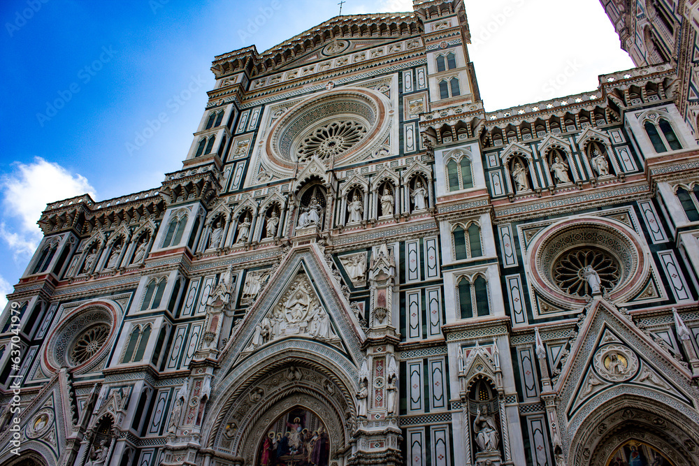 The grand entrance of the Florence Cathedral captivates with its intricate marble work and majestic rose window, a breathtaking example of Gothic and Renaissance fusion.