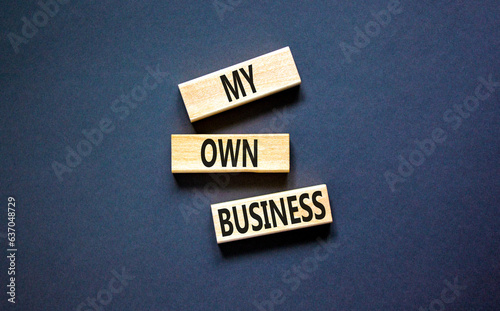 My own business symbol. Concept words My own business on wooden block. Beautiful black table black background. Business motivational my own business concept. Copy space.
