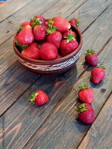Strawberries on a natural wood background. High quality photo