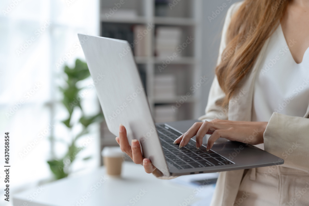 Close-up of hand of businesswoman working using laptop computer. Close-up of hand of businesswoman working using laptop computer.