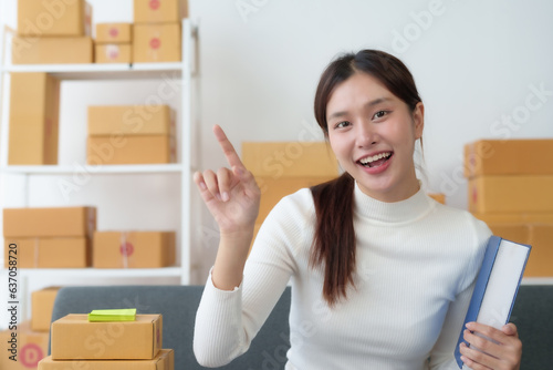Startup happy Asian woman business owner online selling at home office, Startup small business owner working Online selling. SME Online marketing and product packaging and delivery service.
