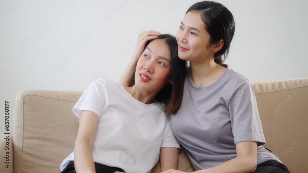 Affection LGBT concept. Happy diverse beautiful asian female lesbian couple talking together in living room. Spending quality time, joy, technology and love. 4k resolution. Affection LGBT concept. Happy diverse beautiful asian female lesbian couple talking together in living room. Spending quality time, joy, technology and love. 4k resolution.