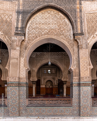 Traditional oriental facade at the courtyard of madrasa Bou Inaniya in the medina of Fes photo