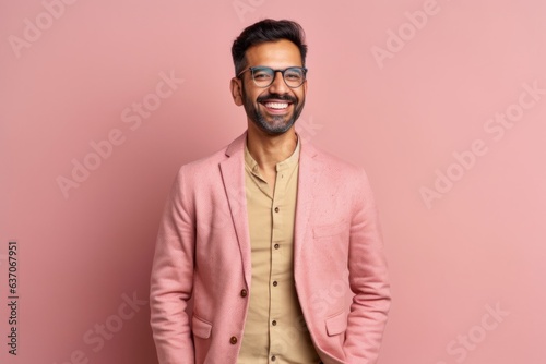 Portrait of a young indian man in a pink suit and glasses © Leon Waltz