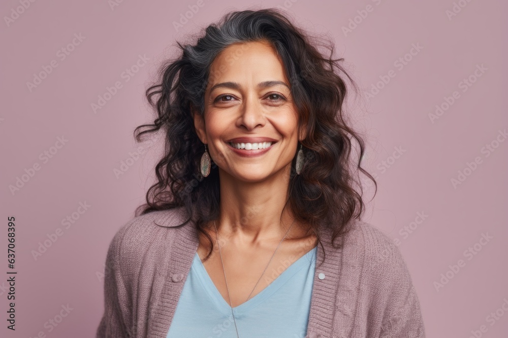 Portrait of a beautiful woman with long curly hair smiling at the camera Portrait of a beautiful woman with long curly hair smiling at the camera