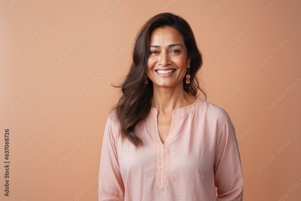 Portrait of a smiling young woman looking at camera isolated over beige background Portrait of a smiling young woman looking at camera isolated over beige background