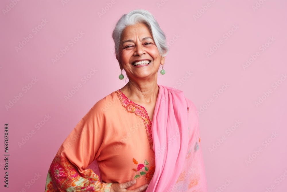 Portrait of a happy senior asian woman smiling against pink background Portrait of a happy senior asian woman smiling against pink background