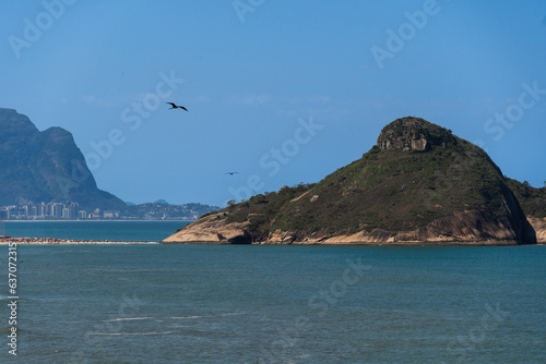 Pedra do Pontal, Morro do Pontal de Sernambetiba, rock formation located in the middle of the sea at Macumba Beach and Recreio dos Bandeirantes in Rio de Janeiro, Brazil. west side of town. Sunny day.