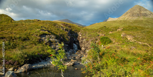 Beautiful waterfall in Glenbrittle, Isle of Skye, with the Cuillin mountains in the distance