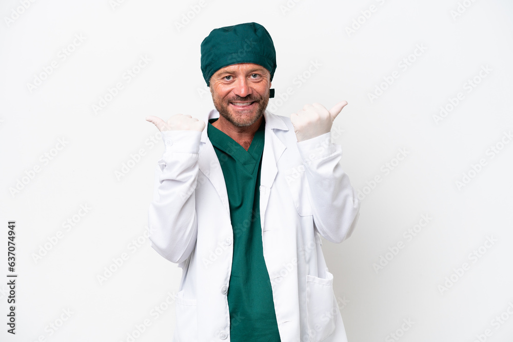 Middle age surgeon in green uniform isolated on white background with thumbs up gesture and smiling Middle age surgeon in green uniform isolated on white background with thumbs up gesture and smiling