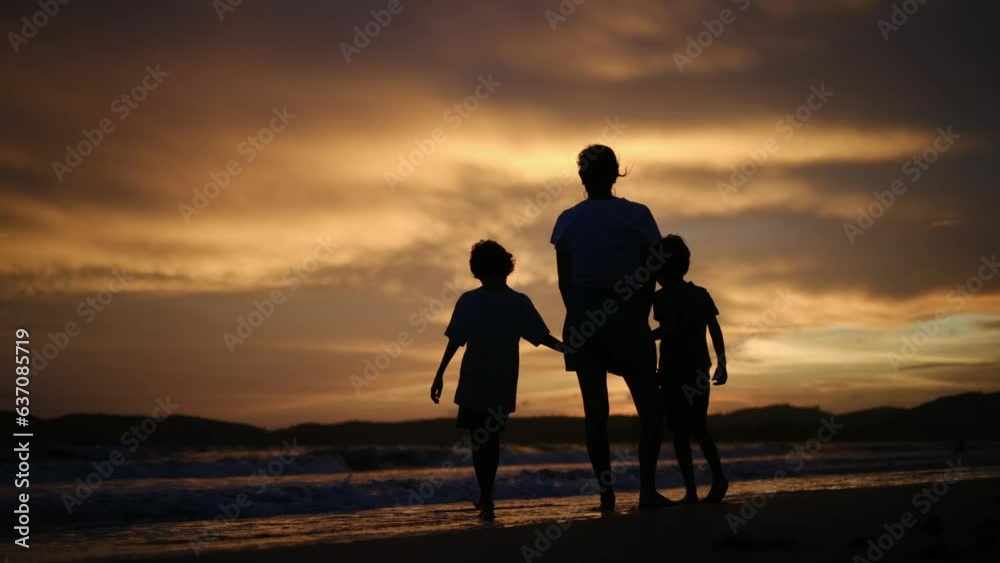 happy family. mother and kids by the sea at sunset silhouette. mother and child kids reach out to the sun. kid dream concept. happy family little kids and dad alone with nature relax sunset concept happy family. mother and kids by the sea at sunset silhouette. mother and child kids reach out to the sun. kid dream concept. happy family little kids and dad alone with nature relax sunset concept