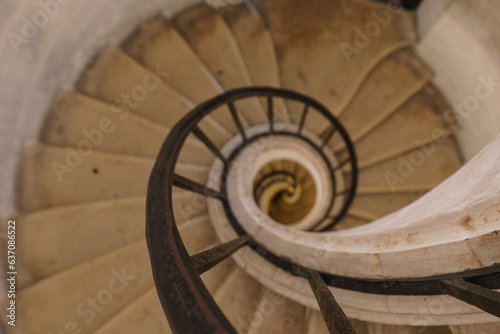 Beautiful old dilapidated spiral staircase with a metal railing destroyed.
