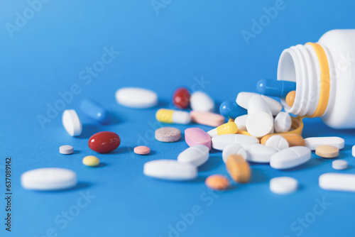 Pills on a blue, medical background