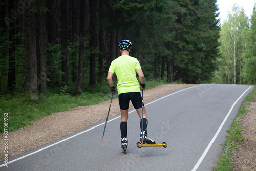 A man on a roller ski rides in the park.Cross country skilling. © Александр Поташев