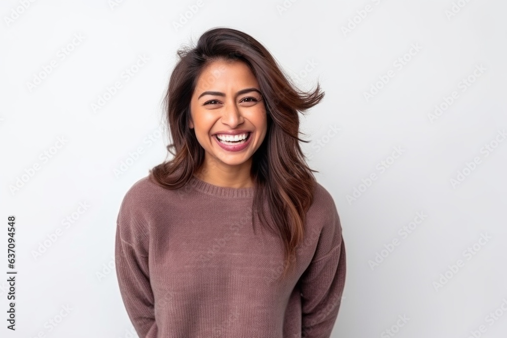 Medium shot portrait of an Indian woman in her 30s against a white background Medium shot portrait of an Indian woman in her 30s against a white background