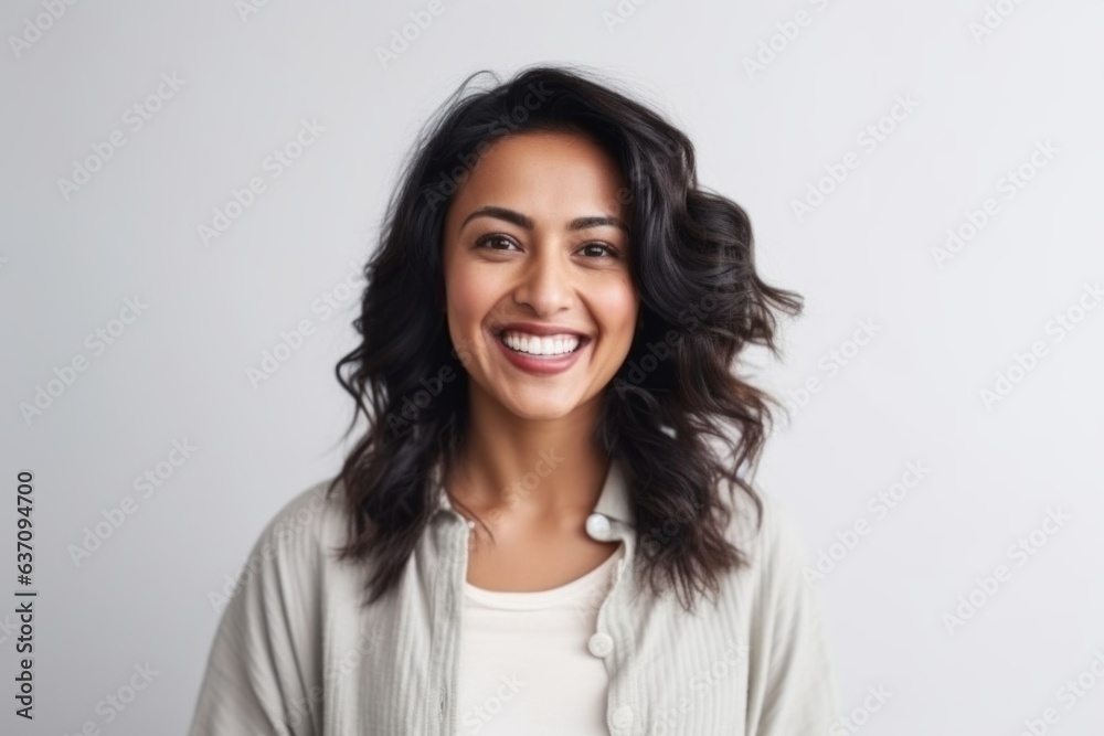 Medium shot portrait of an Indian woman in her 30s against a white background Medium shot portrait of an Indian woman in her 30s against a white background