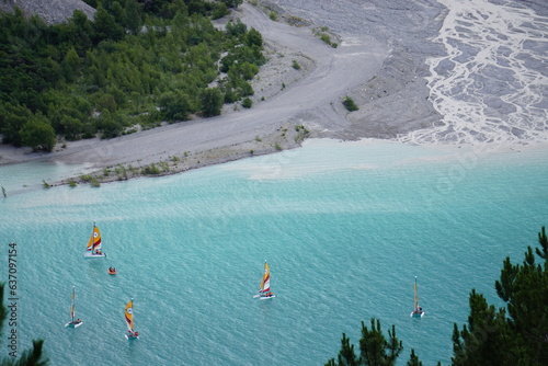 view from the top of the mountain of several catamaran on Serre Ponçon lake, Southern Alps, France by the Boscodon river