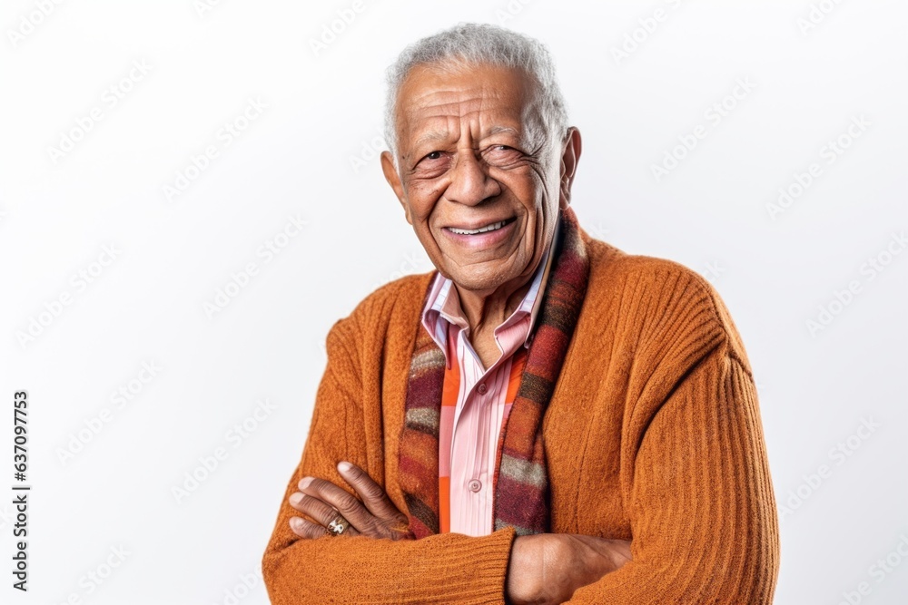Lifestyle portrait of an Indian man in his 80s against a white background Lifestyle portrait of an Indian man in his 80s against a white background