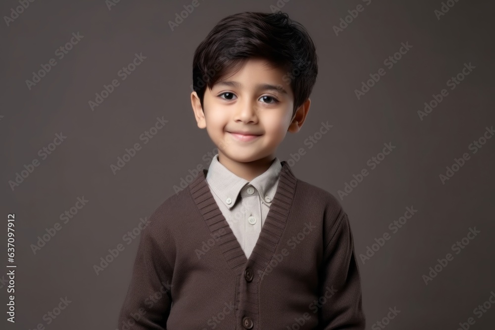 Medium shot portrait of an Indian child male in a minimalist background Medium shot portrait of an Indian child male in a minimalist background