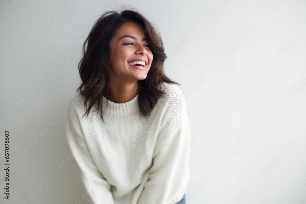 Lifestyle portrait of an Indian woman in her 30s in a minimalist background Lifestyle portrait of an Indian woman in her 30s in a minimalist background