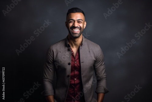 Lifestyle portrait of an Indian man in his 30s in a minimalist background