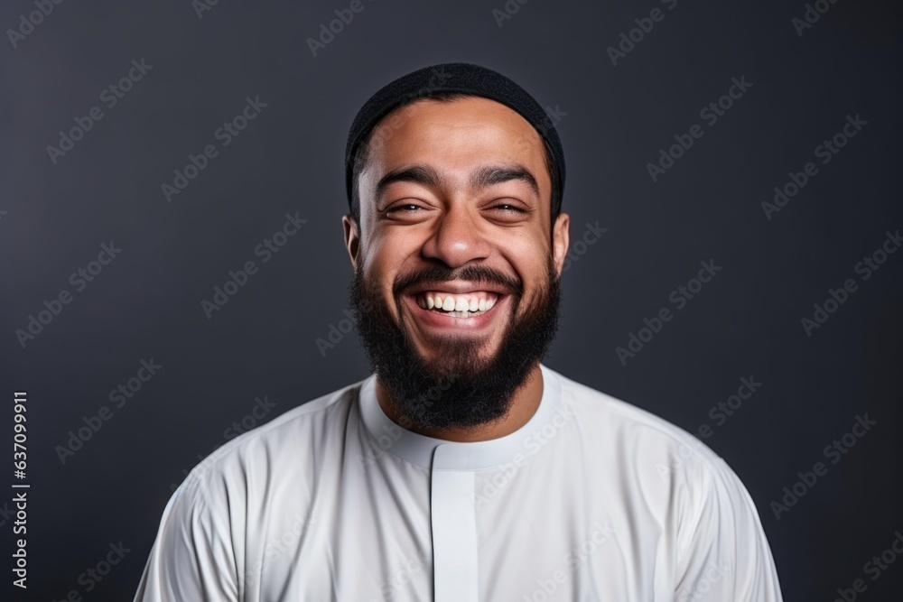Medium shot portrait of an Indian man in his 30s wearing hijab in a minimalist background
