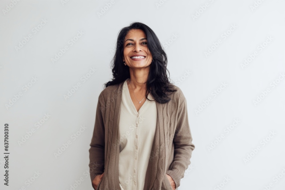 Lifestyle portrait of an Indian woman in her 40s in a minimalist background Lifestyle portrait of an Indian woman in her 40s in a minimalist background