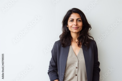 Lifestyle portrait of an Indian woman in her 40s in a minimalist background