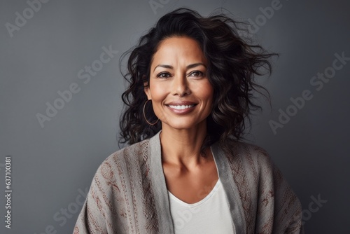Lifestyle portrait of an Indian woman in her 40s in a minimalist background
