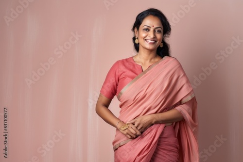 Obraz na płótnie Medium shot portrait of an Indian woman in her 40s wearing traditional sari in a minimalist background w salonie