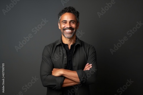 Medium shot portrait of an Indian man in his 40s in a minimalist background