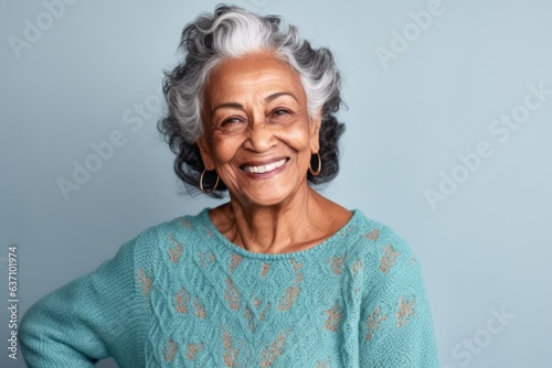 Lifestyle portrait of an Indian woman in her 70s in a minimalist background