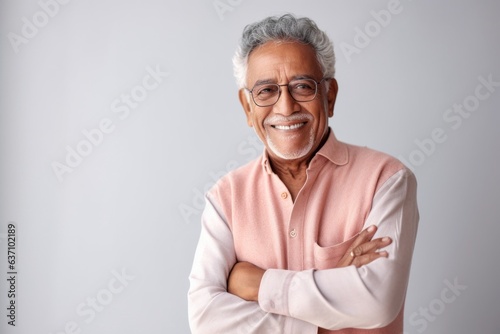 Lifestyle portrait of an Indian man in his 80s in a minimalist background