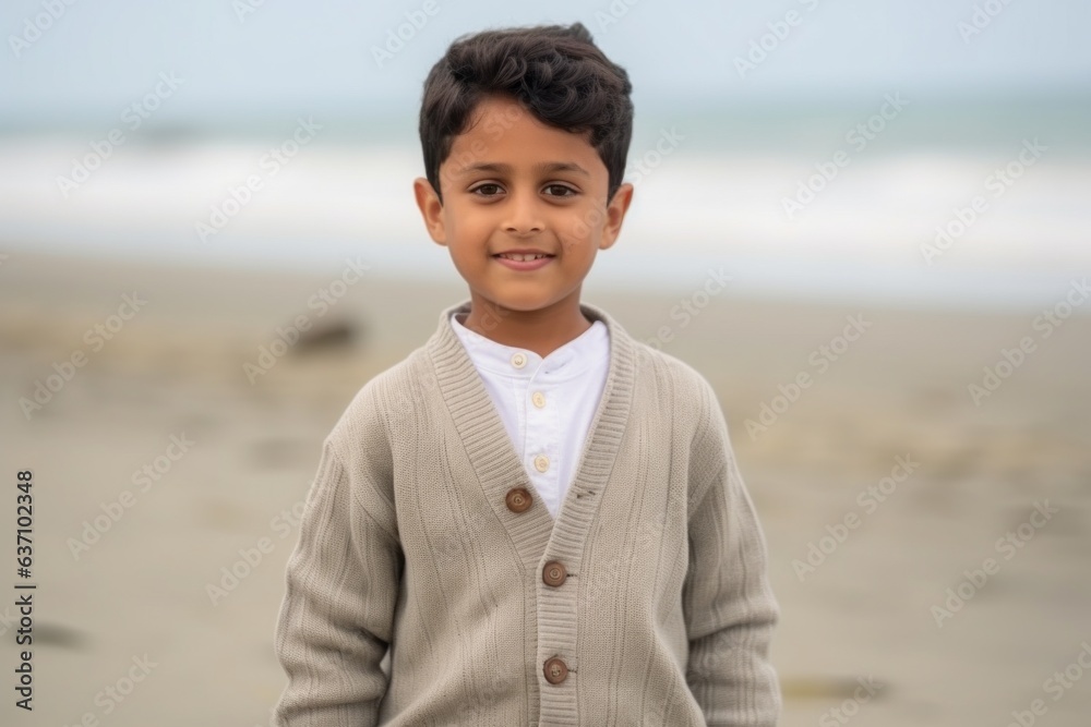 Medium shot portrait of an Indian child male in a beach Medium shot portrait of an Indian child male in a beach