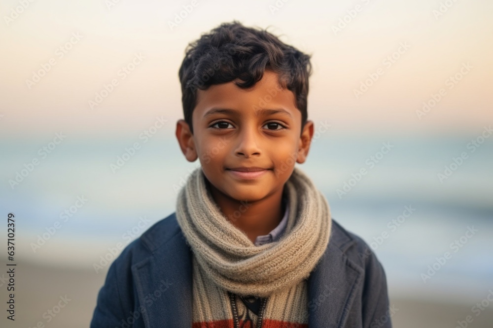 Medium shot portrait of an Indian child male in a beach Medium shot portrait of an Indian child male in a beach