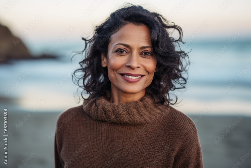 Group portrait of an Indian woman in her 40s in a beach 