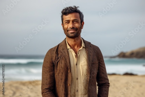 Group portrait of an Indian man in his 30s in a beach 