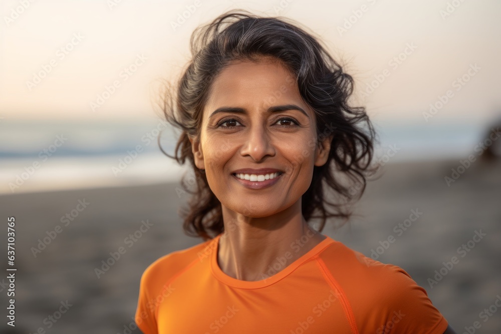 Lifestyle portrait of an Indian woman in her 40s wearing a sporty polo shirt in a beach Lifestyle portrait of an Indian woman in her 40s wearing a sporty polo shirt in a beach