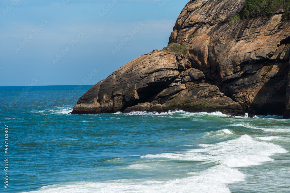 Joatinga Beach, a paradise in Rio de Janeiro, Brazil. Sunny day in the morning. Emerald green sea with good waves for surfers. Mountains and hills around and a lot of nature