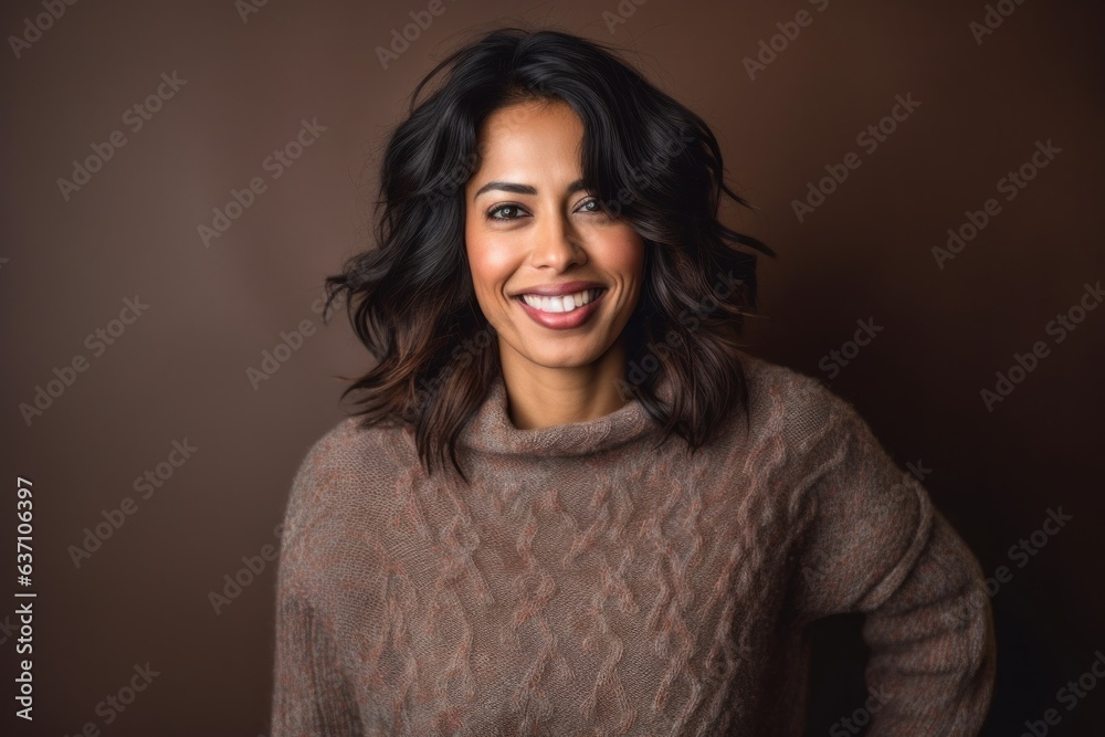 Fototapeta premium Beautiful brunette woman in a brown sweater on a brown background