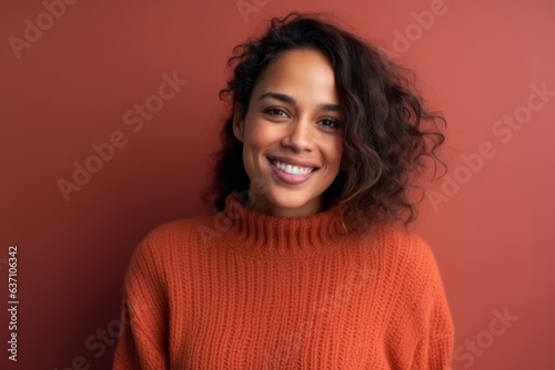 Portrait of a beautiful young woman with curly hair on a red background